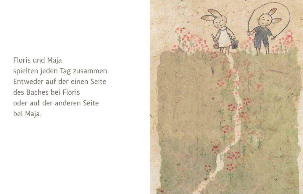 Floris und Maja: Zwei Hasen spielen zusammen neben Text