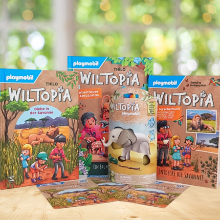 Drei PLAYMOBIL Wiltopia Bücher stehend und ein Elefant in seiner Verpackung